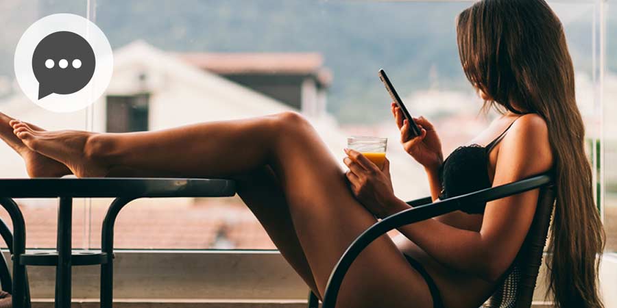 Woman wearing lingerie using mobile device to instant message.