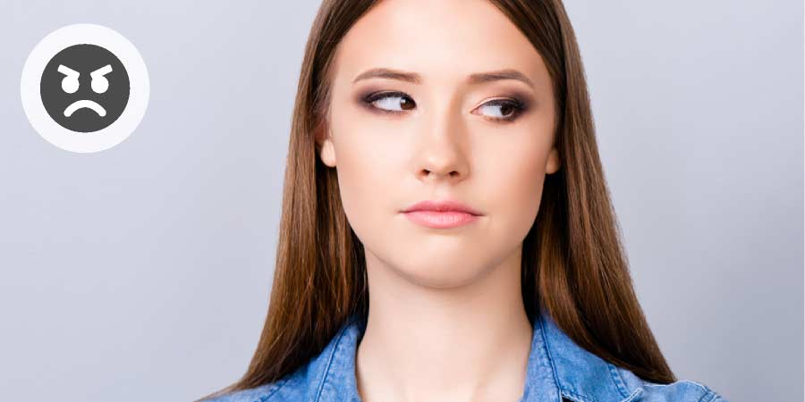 Woman looking concerned and glancing away from camera.