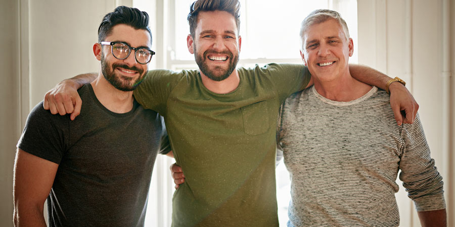 Three attractive single men smiling at the camera